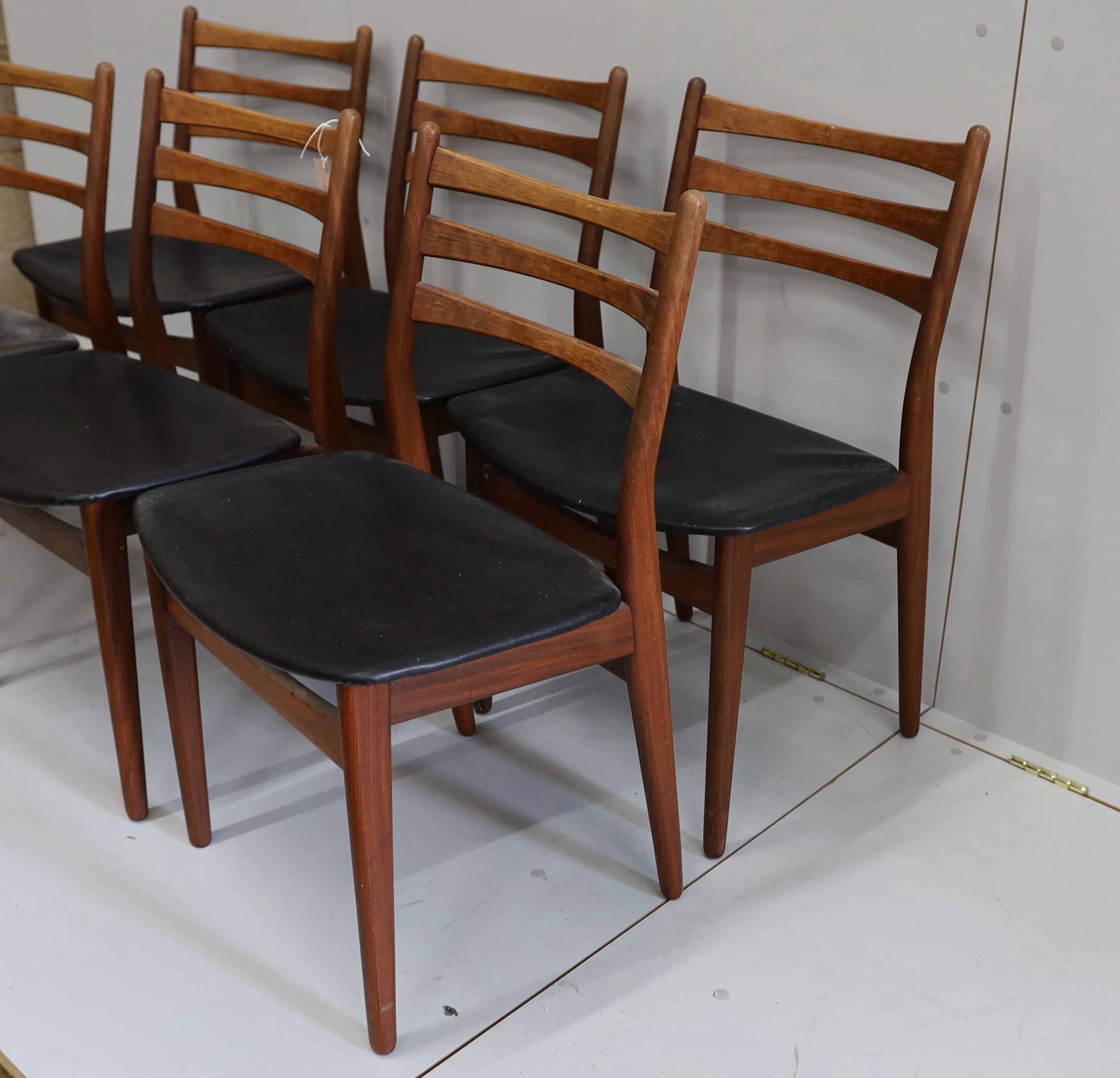 A set of six mid century, Danish design, teak and black leatherette dining chairs, width 50cm, depth 40cm, height 80cm